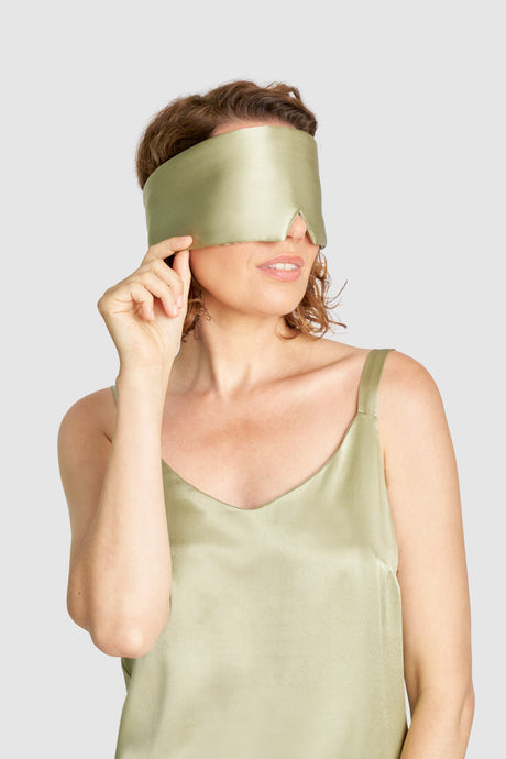 Eco-friendly Sage sleep mask made from cruelty-free peace silk and biodegradable Lyocell, shown on model