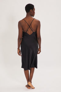 Ethical Kind Organic Peace Silk Slip Midi Night Dress in Black with adjustable cross back straps.